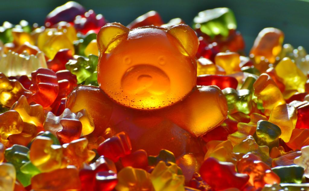 A gummy bear that, like many candies, is coated in a thin veil of wax