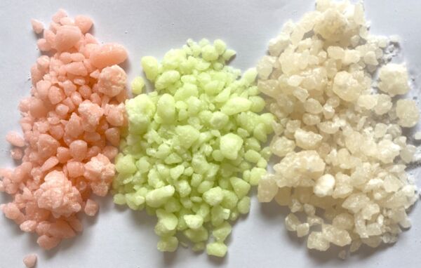 granules of multi-coloured paraffin wax used for beauty applications